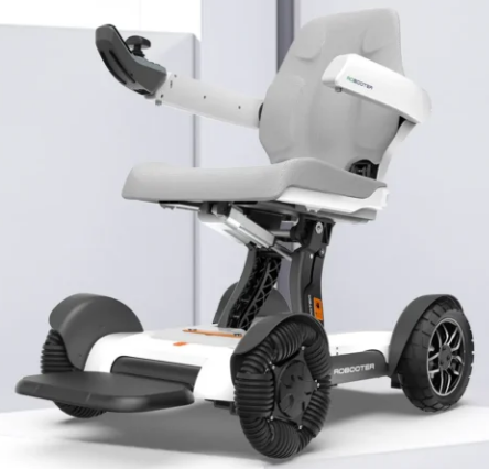 A compact, modern mobility scooter with a grey seat and four wheels.